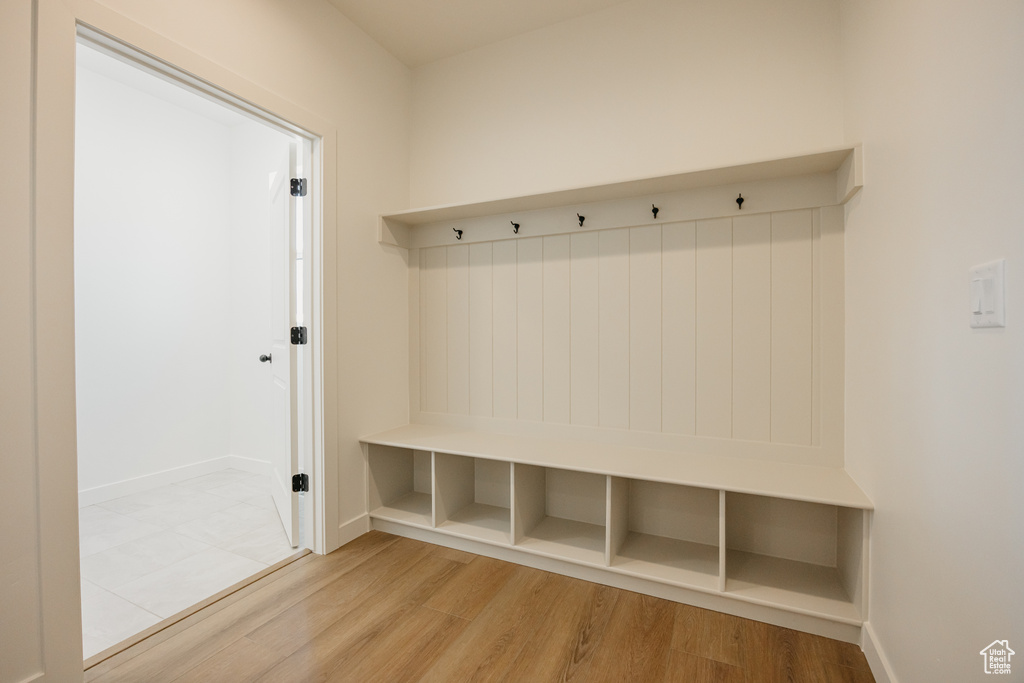 Mudroom with wood finished floors and baseboards