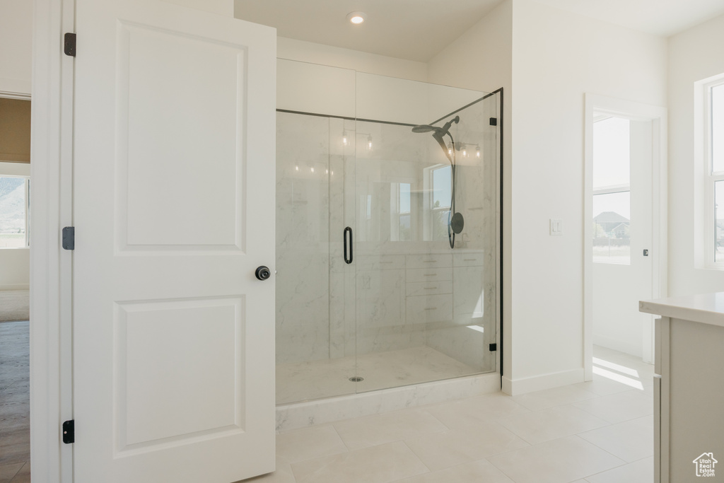 Full bath featuring a stall shower, tile patterned floors, baseboards, recessed lighting, and vanity
