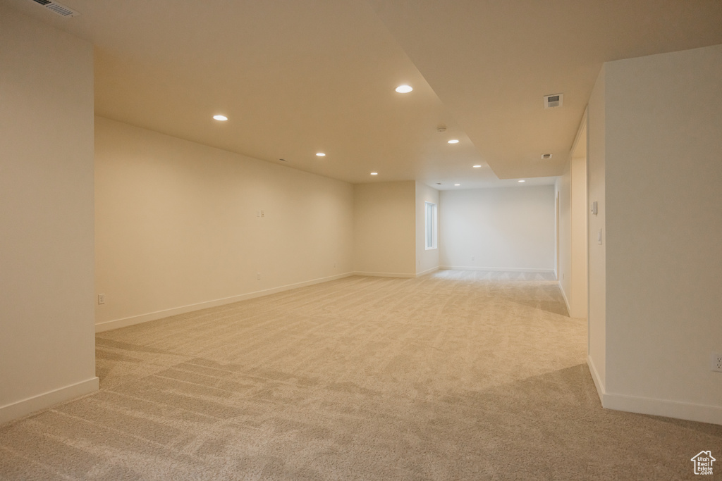 Unfurnished room featuring recessed lighting, light carpet, and baseboards