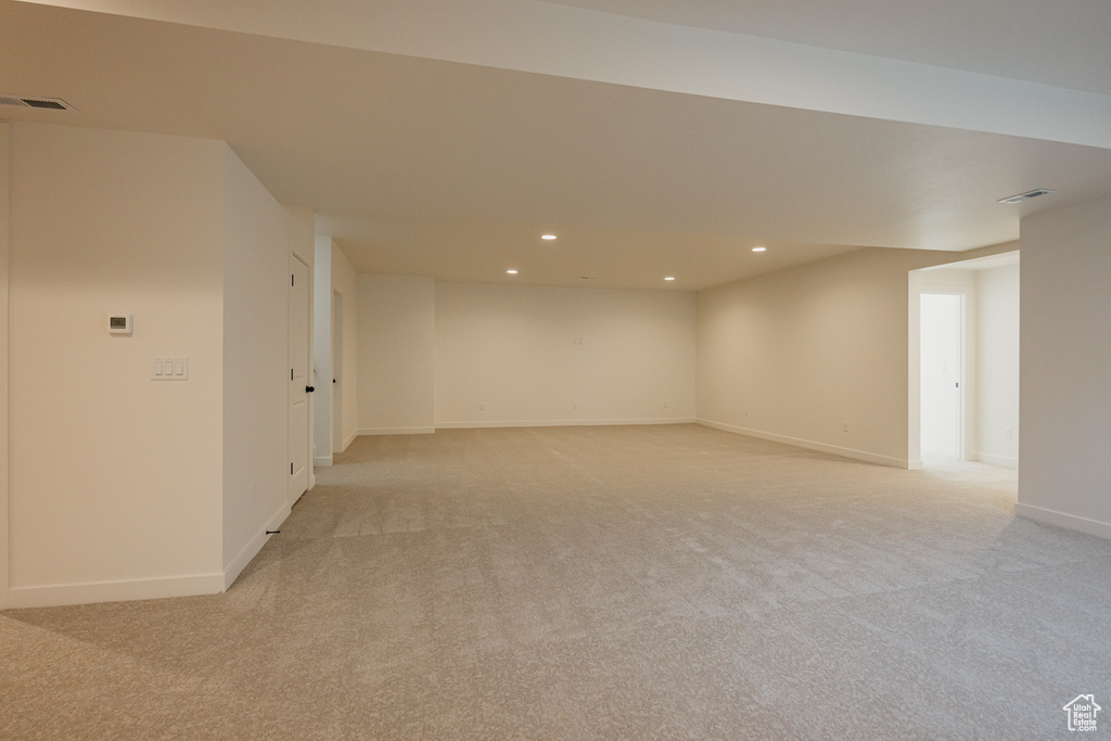 Unfurnished room featuring light colored carpet, recessed lighting, and baseboards
