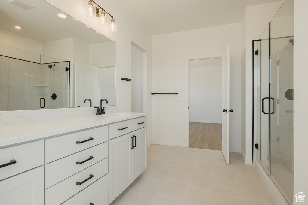 Full bath featuring a stall shower, vanity, recessed lighting, tile patterned floors, and baseboards