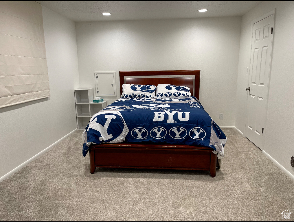Carpeted bedroom featuring recessed lighting and baseboards