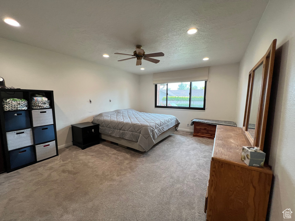 Bedroom with recessed lighting, carpet, a textured ceiling, and baseboards