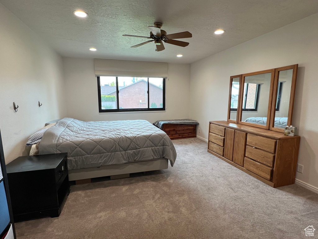Carpeted bedroom with baseboards, recessed lighting, a textured ceiling, and ceiling fan