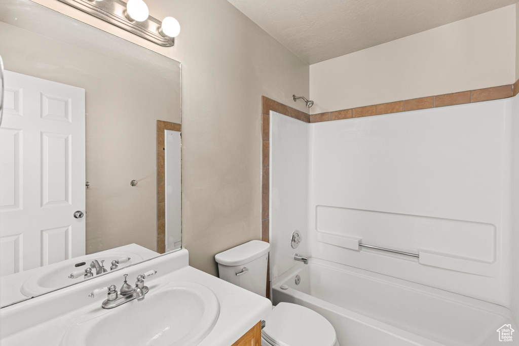Full bath featuring toilet, bathing tub / shower combination, and vanity