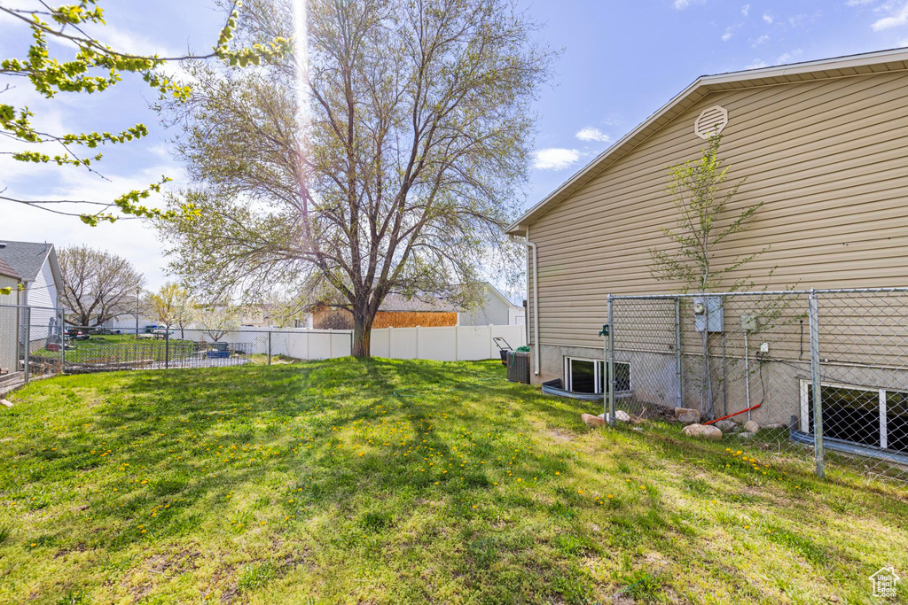 View of yard featuring fence