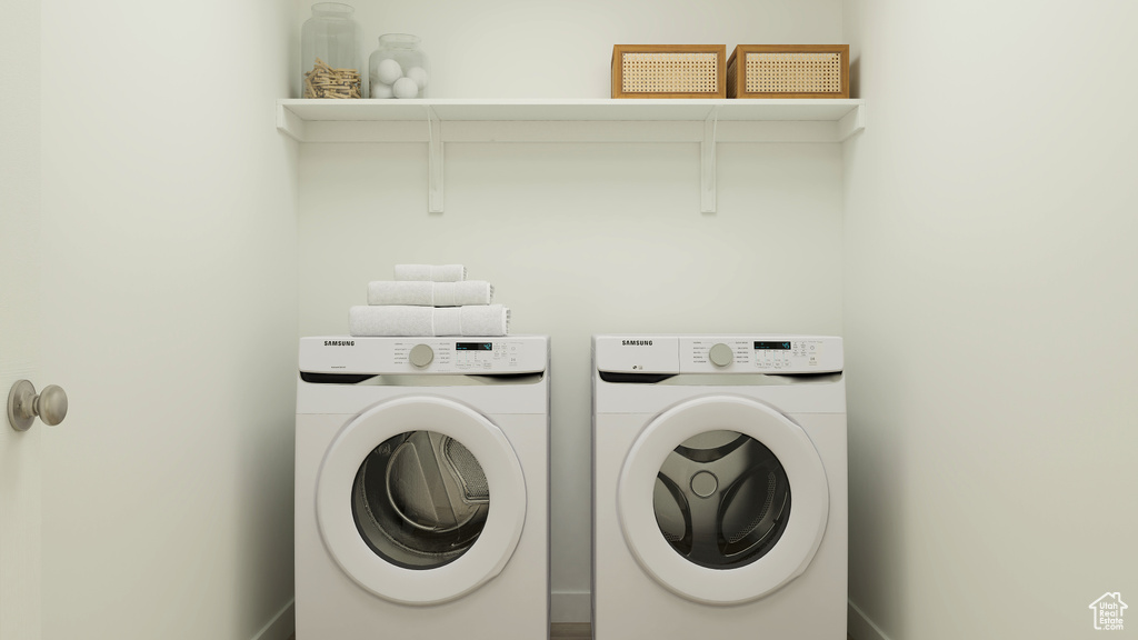 Washroom featuring washing machine and dryer and laundry area