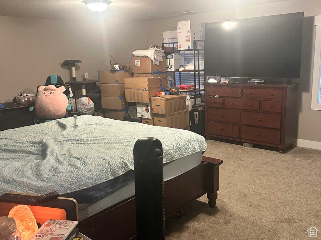 Bedroom featuring light carpet and baseboards
