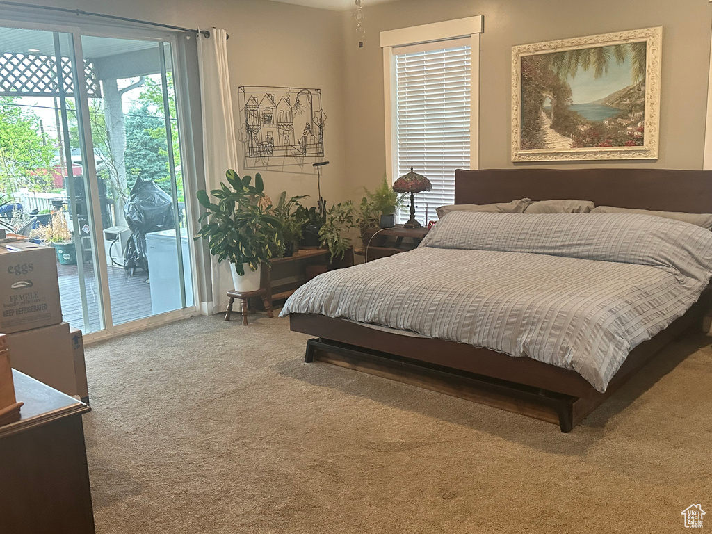 Carpeted bedroom with access to exterior