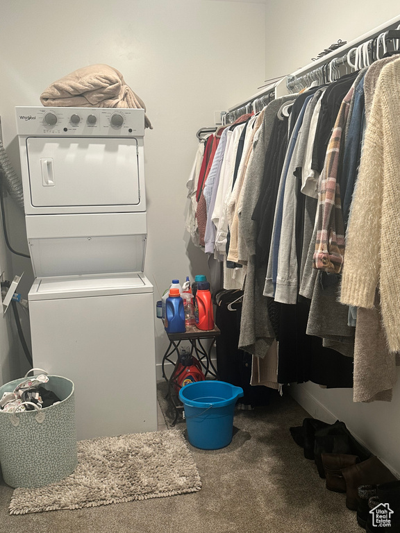Walk in closet featuring carpet and stacked washer and dryer