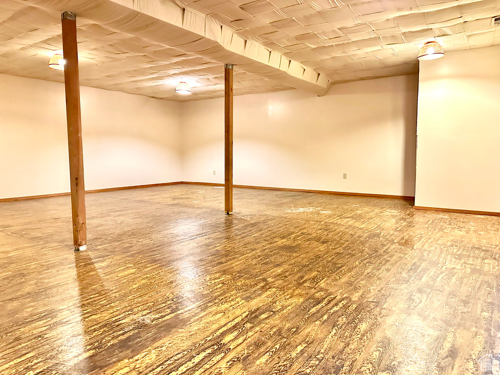 Finished below grade area with wood finished floors and baseboards