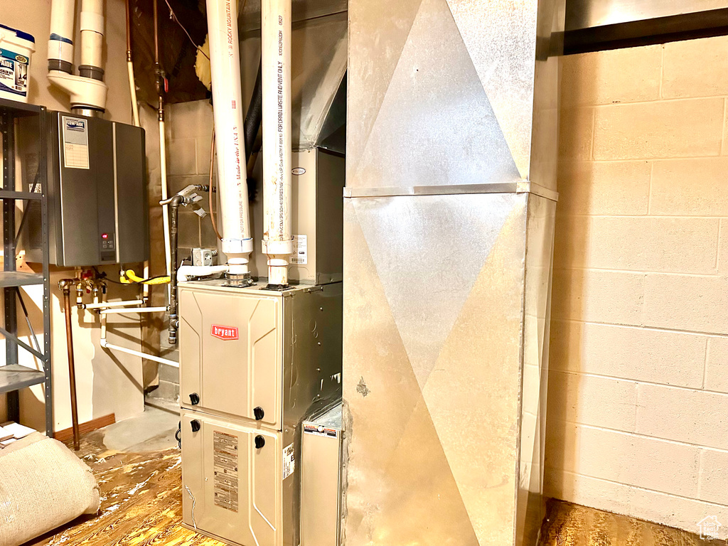 Utility room featuring tankless water heater