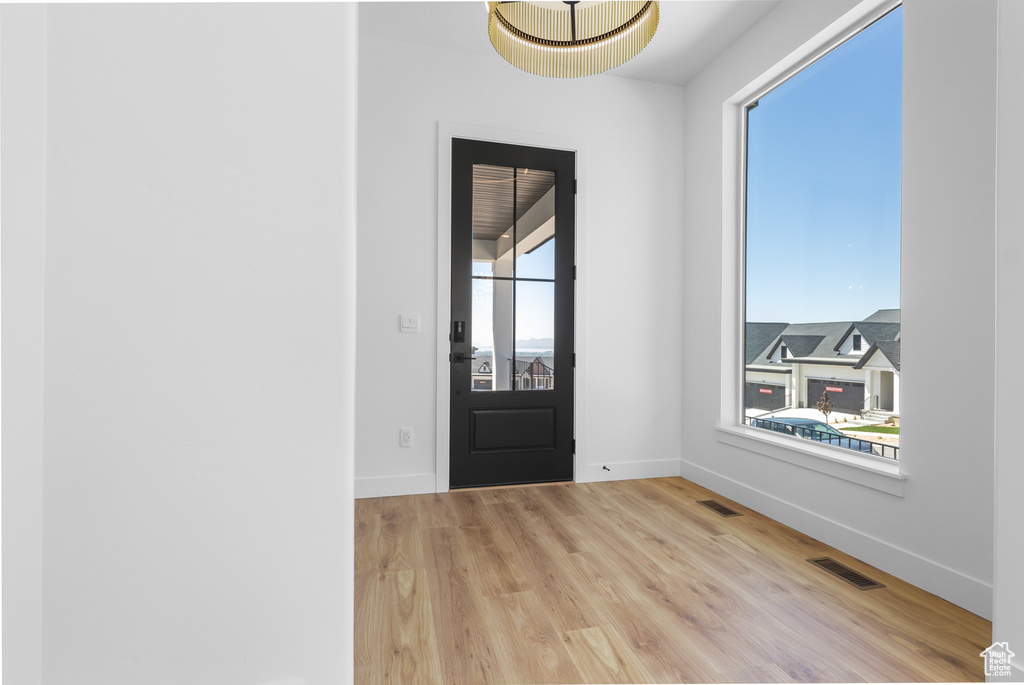 Foyer featuring light wood-style floors and baseboards