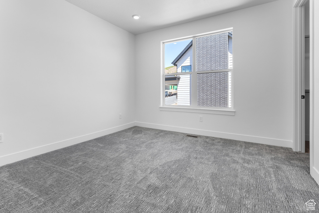 Carpeted empty room with baseboards