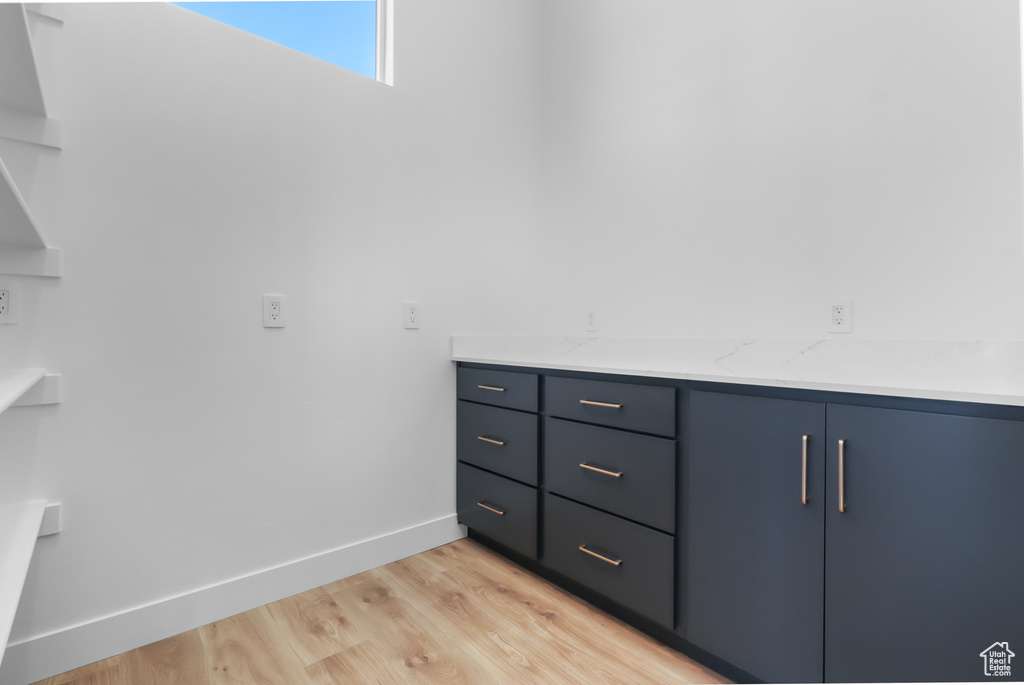 Bathroom with wood finished floors, baseboards, and vanity