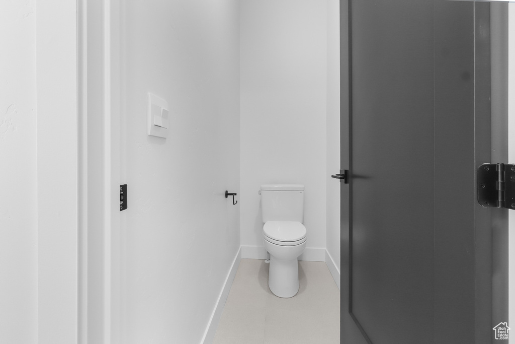 Bathroom featuring toilet and baseboards