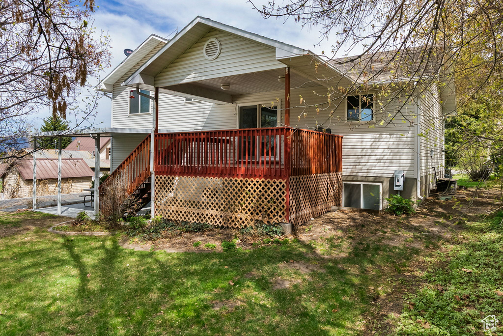 Rear view of property with a lawn