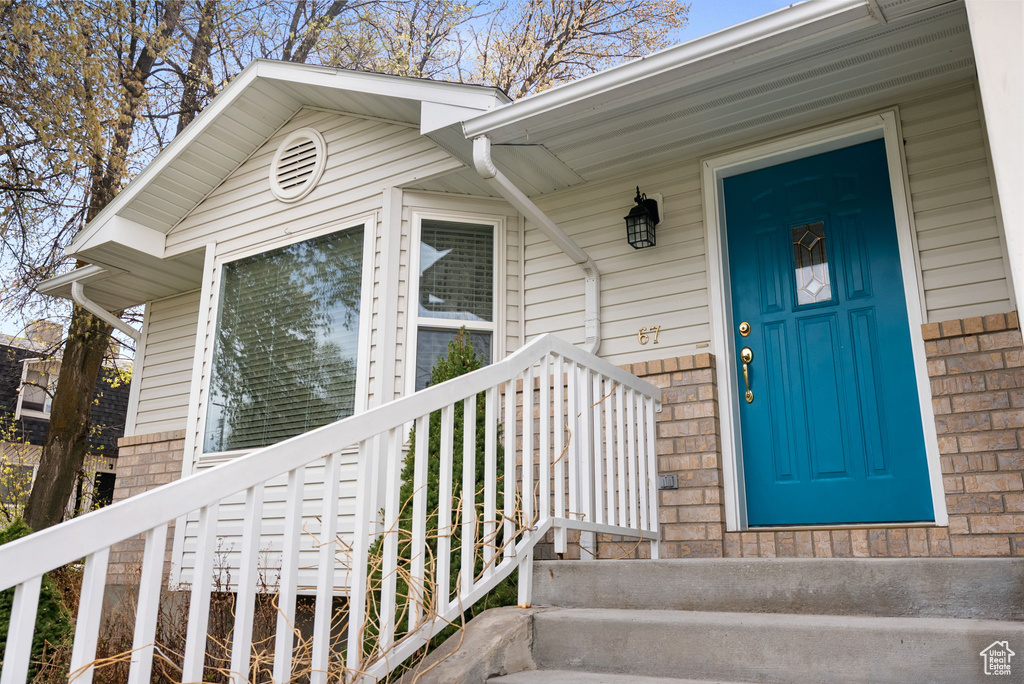 Entrance to property featuring covered porch
