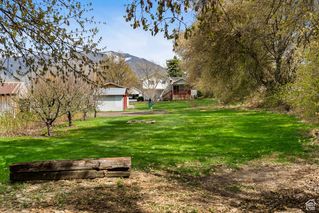 View of yard with stairway and a deck with mountain view
