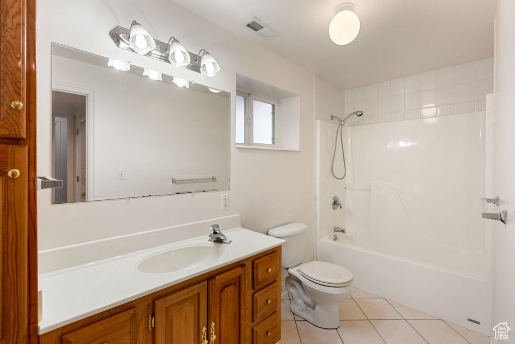 Bathroom with tile patterned floors, vanity,  shower combination, toilet, and visible vents