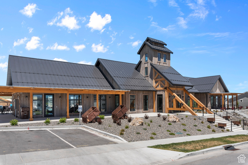 View of building exterior with uncovered parking
