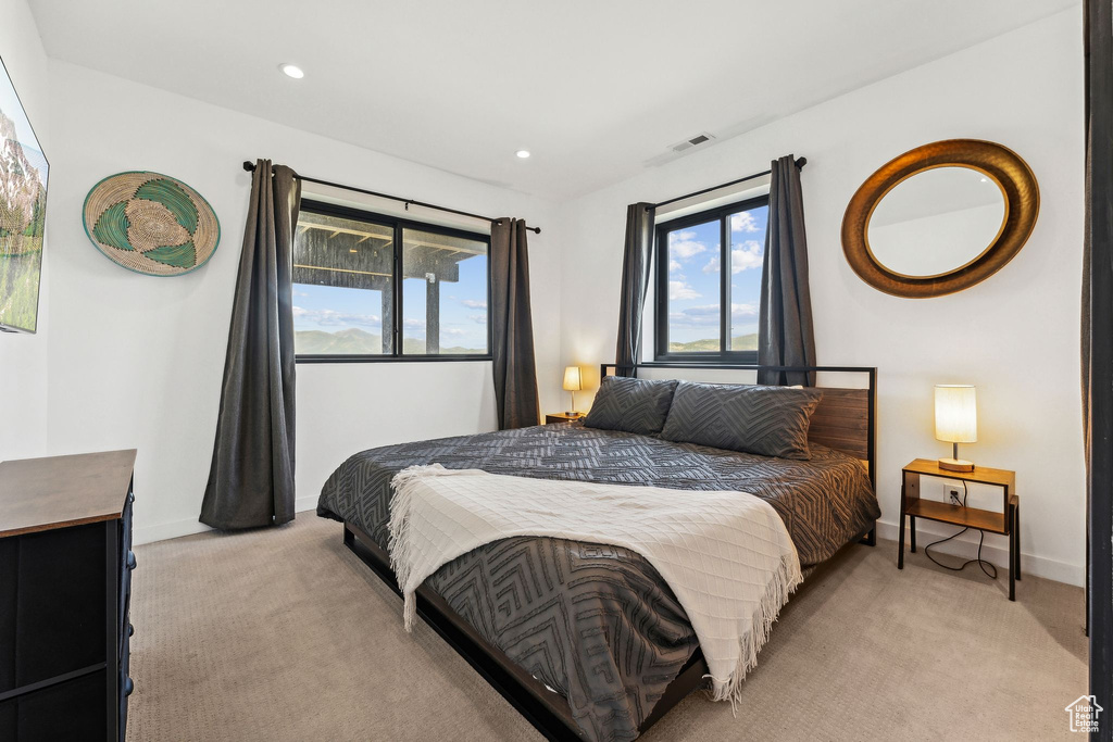 Bedroom featuring recessed lighting, visible vents, light colored carpet, and baseboards