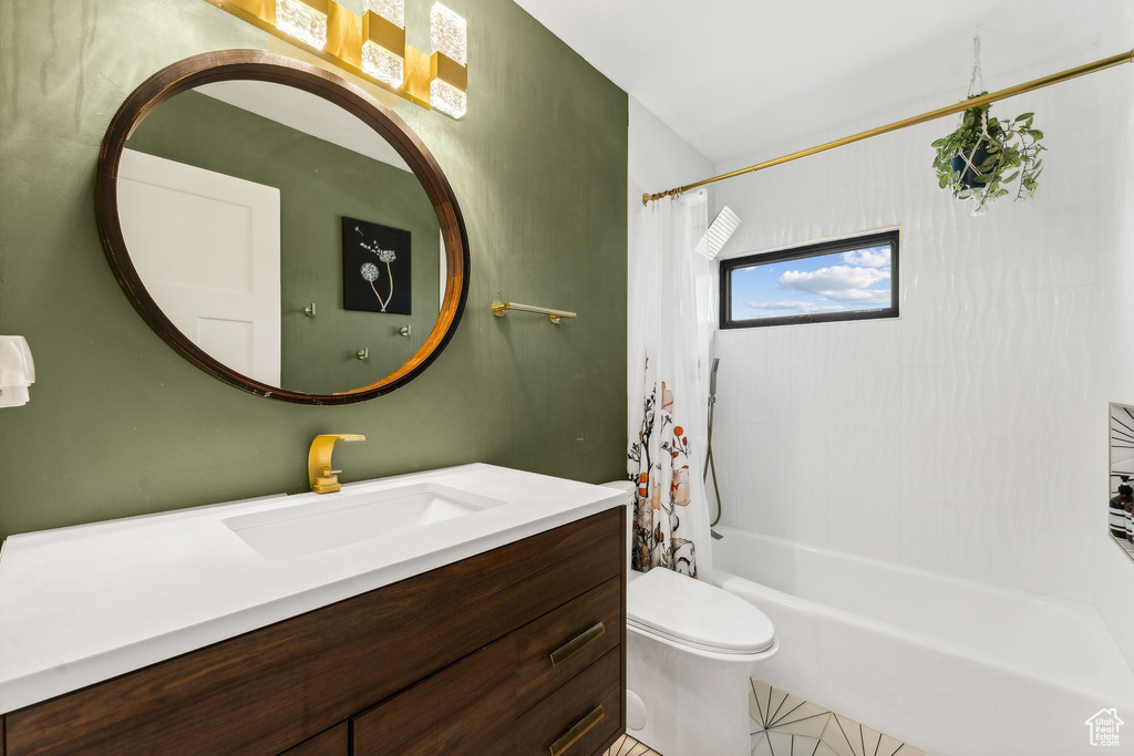 Full bathroom with toilet, vanity, tile patterned flooring, and shower / bath combo with shower curtain