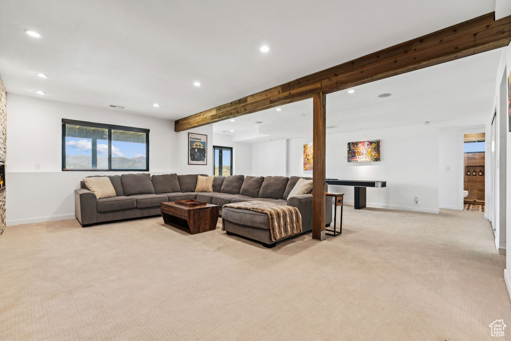 Living room featuring beamed ceiling, light colored carpet, visible vents, recessed lighting, and baseboards