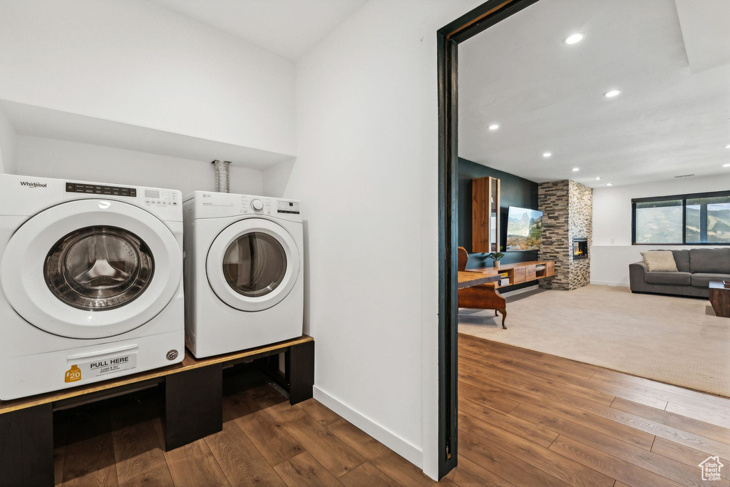 Laundry room with baseboards, recessed lighting, and hardwood / wood-style flooring