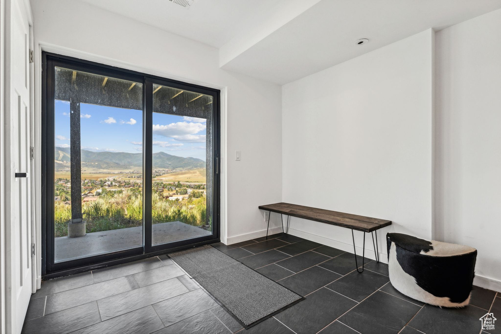 Interior space featuring a mountain view and baseboards