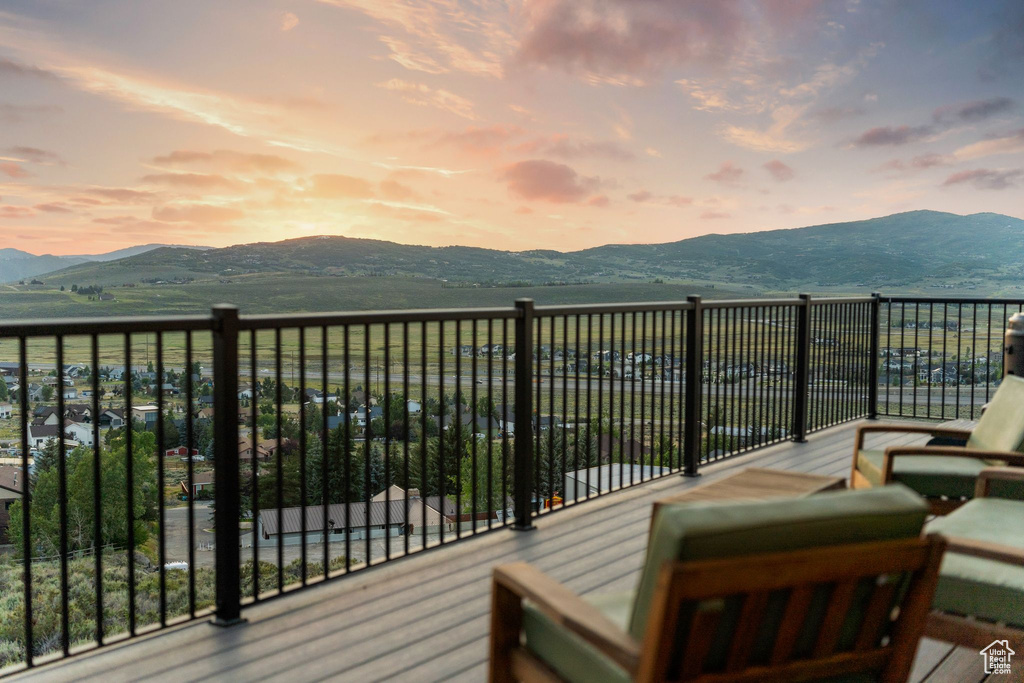Deck at dusk featuring a mountain view