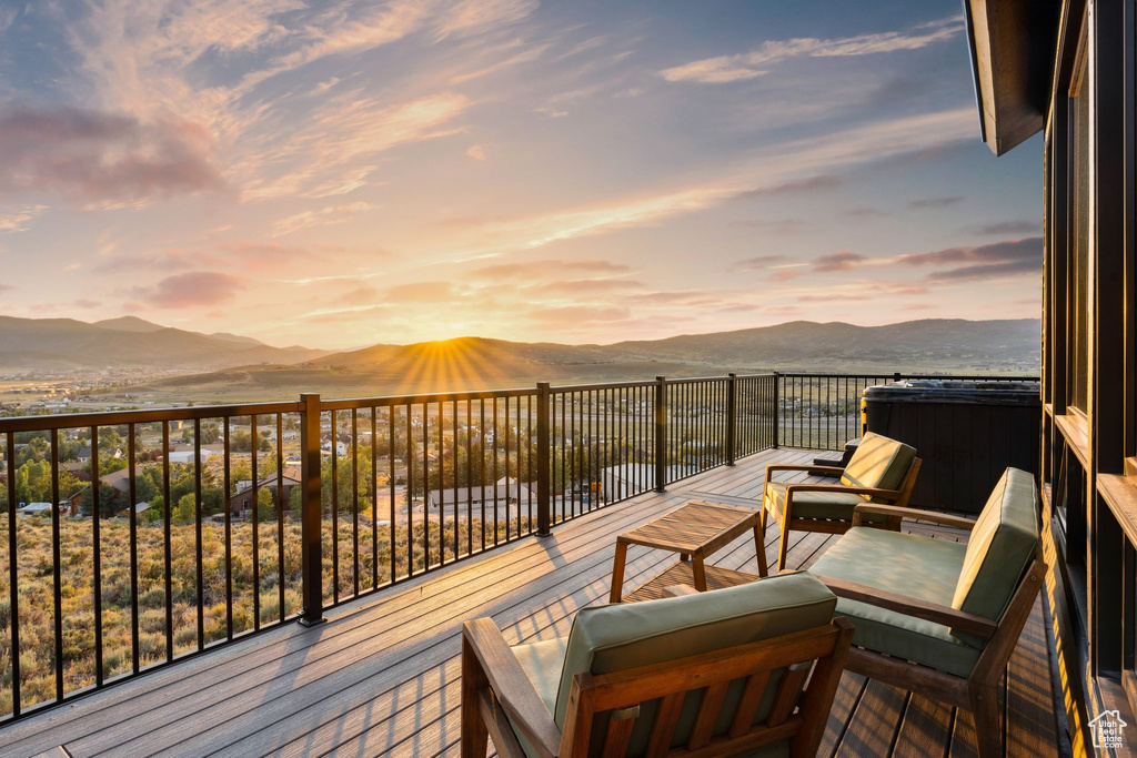 Deck at dusk featuring a mountain view