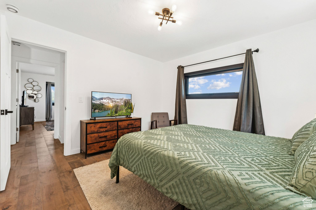 Bedroom with baseboards and wood finished floors