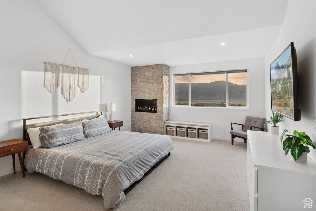 Bedroom featuring baseboards, a stone fireplace, carpet, and recessed lighting