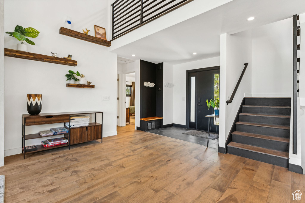 Foyer entrance with recessed lighting, stairway, wood finished floors, and baseboards