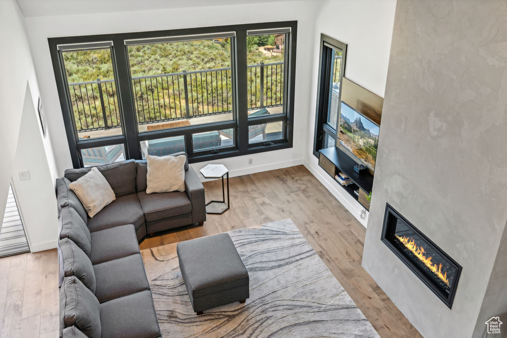Living area with a fireplace, baseboards, and wood finished floors