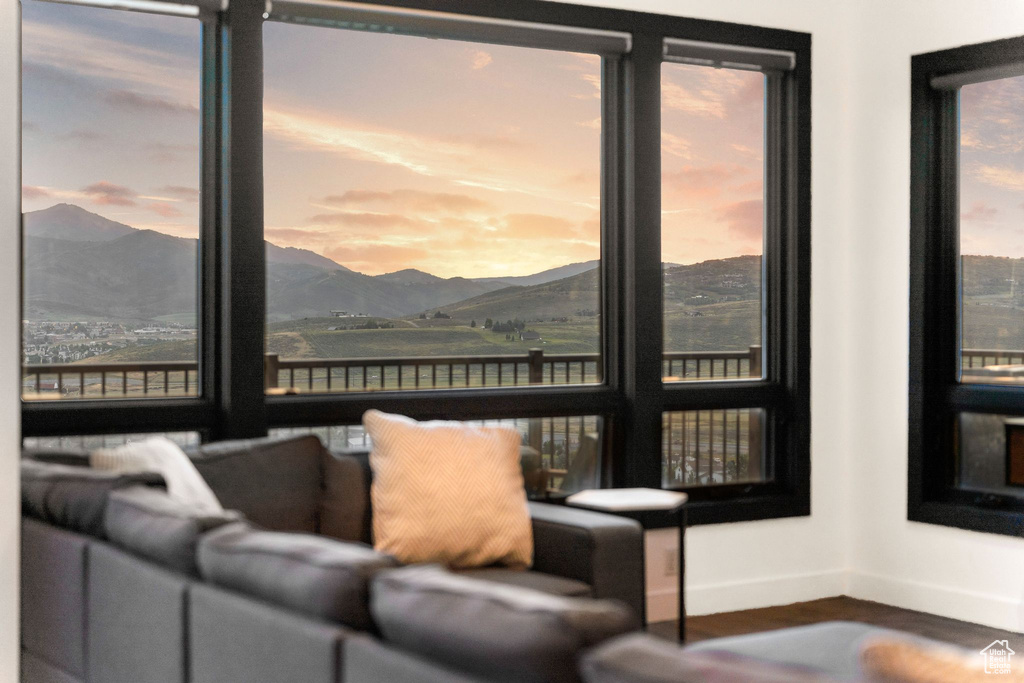 Interior space with a mountain view, baseboards, and wood finished floors