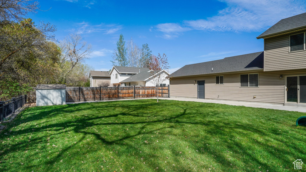 View of yard with a fenced backyard, a shed, and an outdoor structure