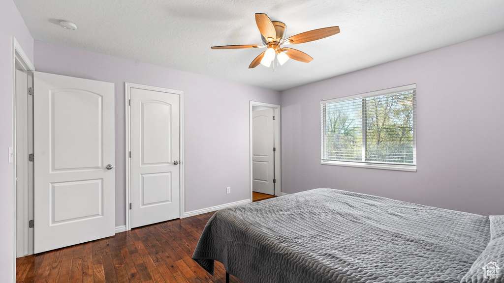 Bedroom featuring baseboards, ceiling fan, and hardwood / wood-style floors