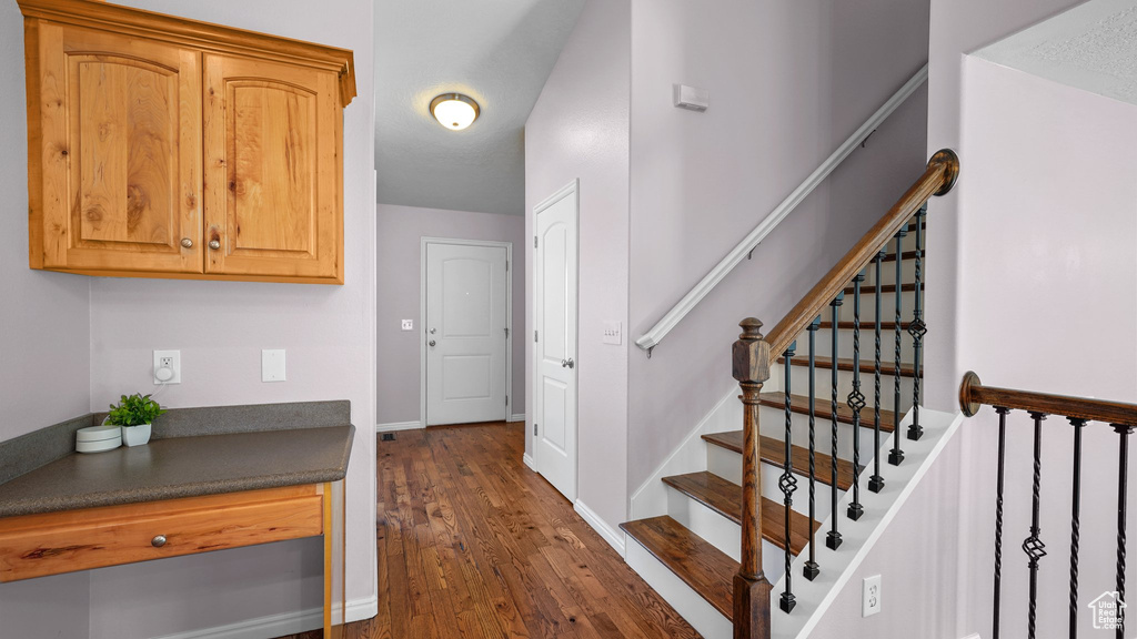 Stairway featuring hardwood / wood-style floors and baseboards