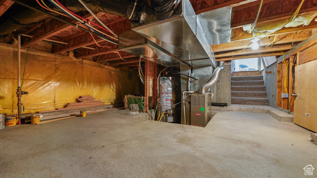Below grade area with water heater and stairway