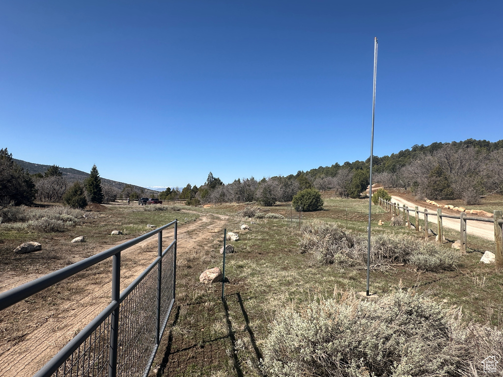 View of yard featuring a rural view and fence