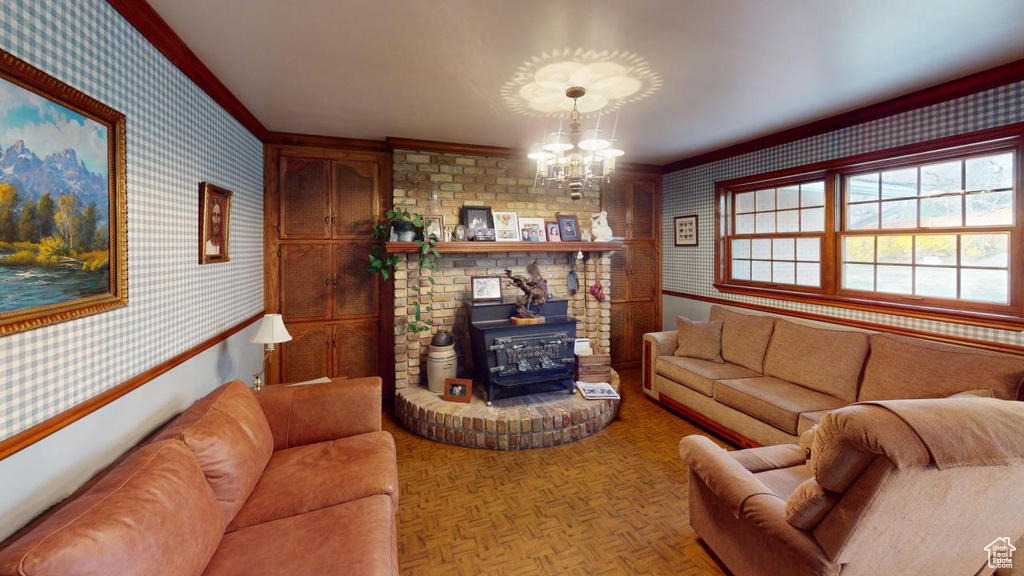Living area featuring wainscoting, wallpapered walls, a wood stove, and ornamental molding
