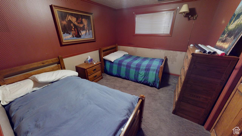 Carpeted bedroom featuring a textured ceiling