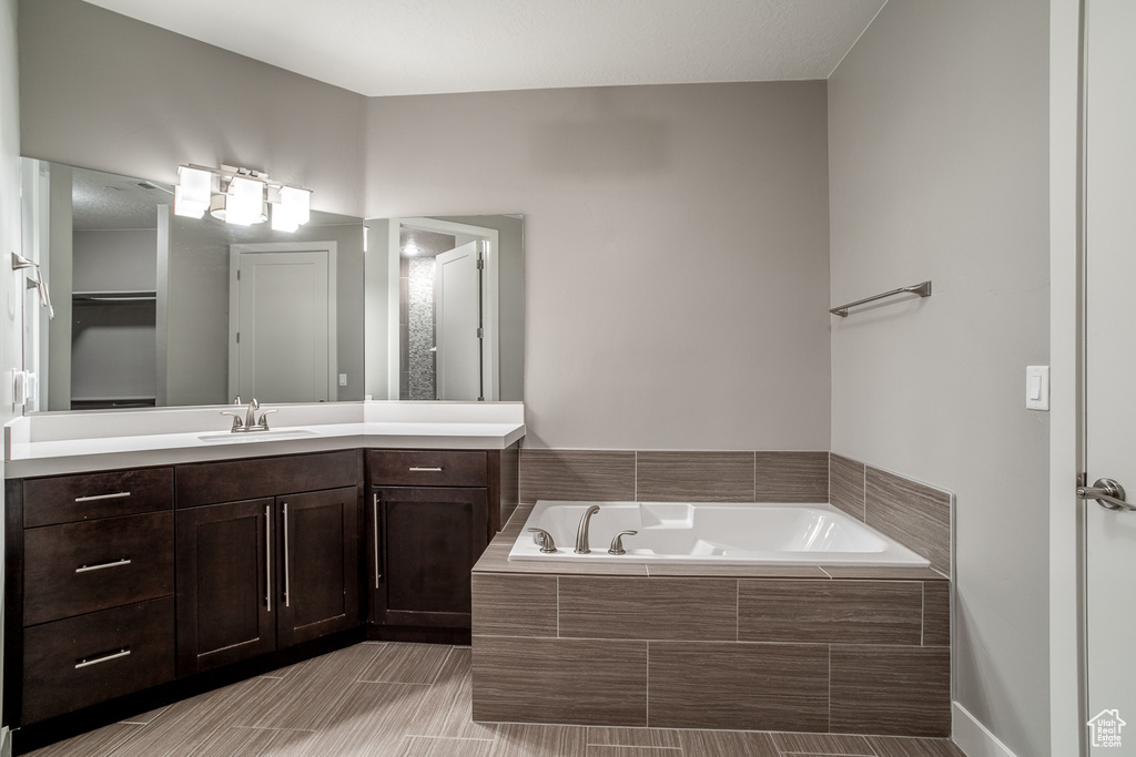 Full bathroom with vanity and a bath
