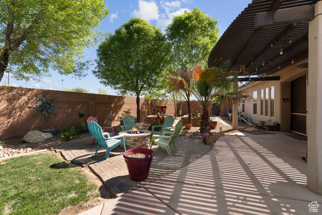 View of patio with a pergola, a fenced backyard, and an outdoor fire pit
