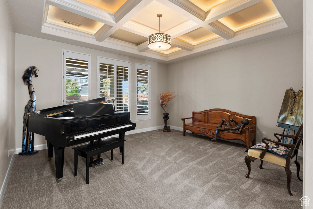 Living area featuring visible vents, baseboards, beamed ceiling, carpet flooring, and coffered ceiling