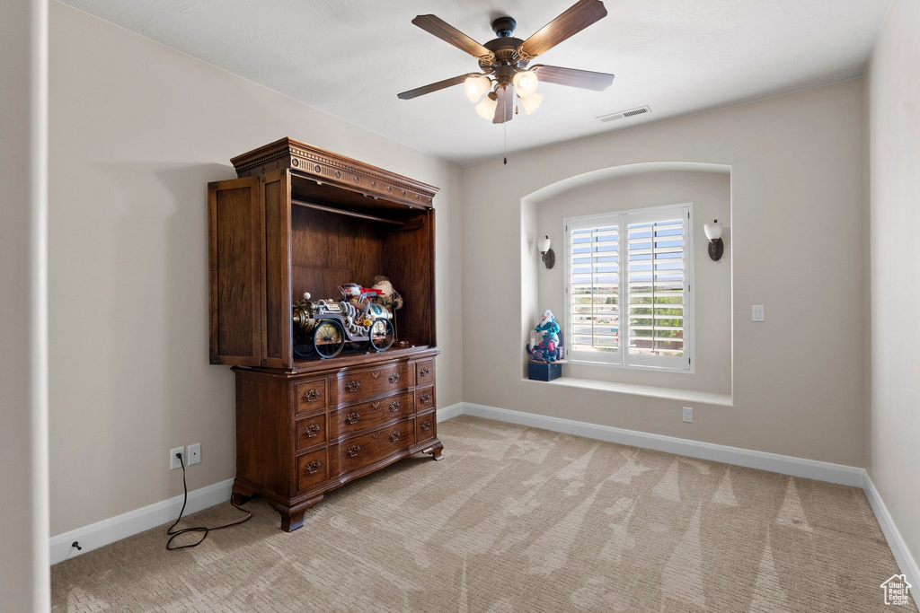 Bedroom with visible vents, light colored carpet, and baseboards