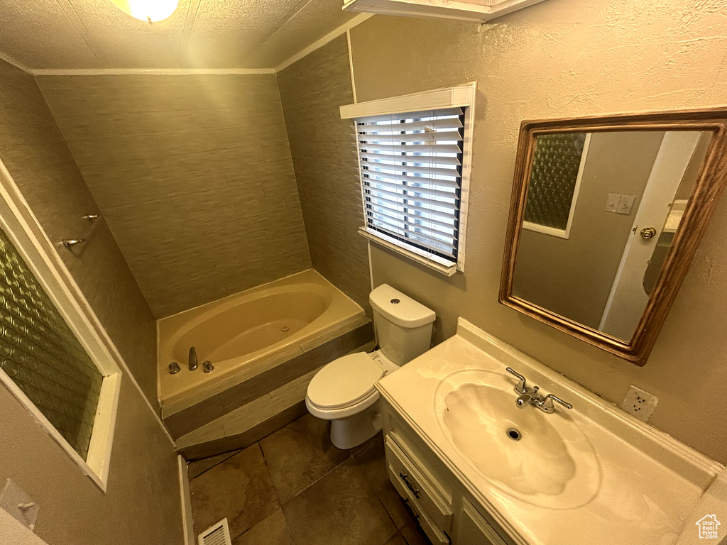 Bathroom with toilet, visible vents, tile patterned floors, and vanity