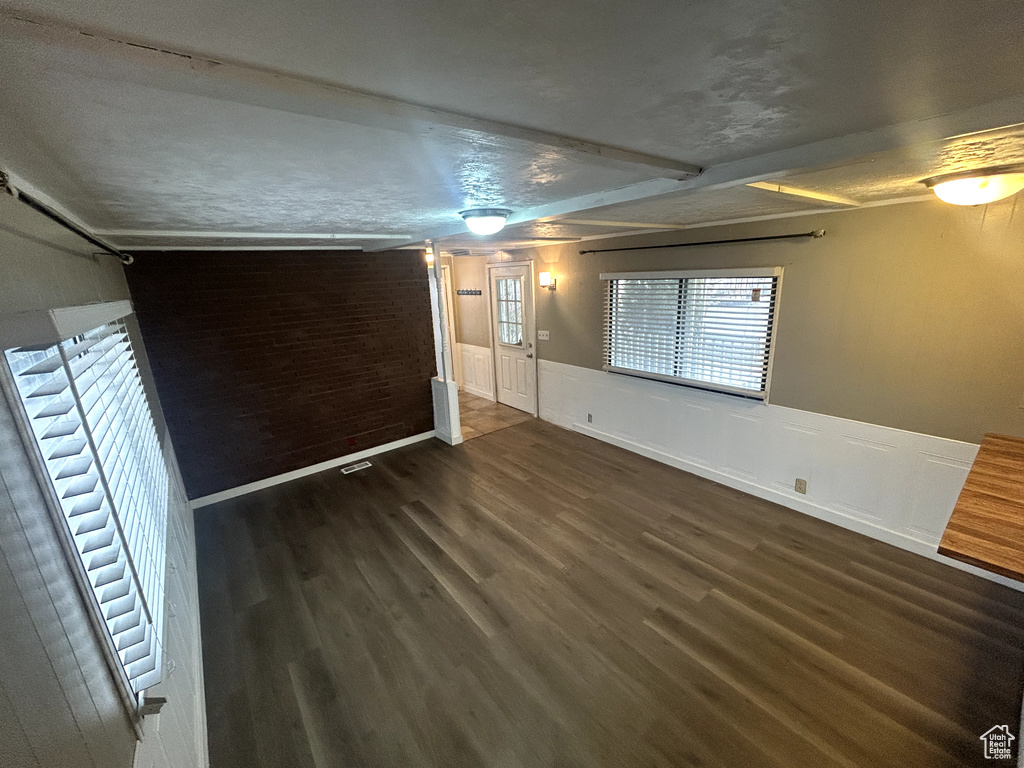 Empty room with wainscoting and wood finished floors